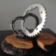 wedding present - Connection of a heart made of horseshoes and a sprocket fixed on an engraved wooden plate.