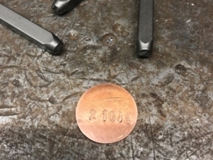 old pennies are used for the frame number, pressed and re-punched.